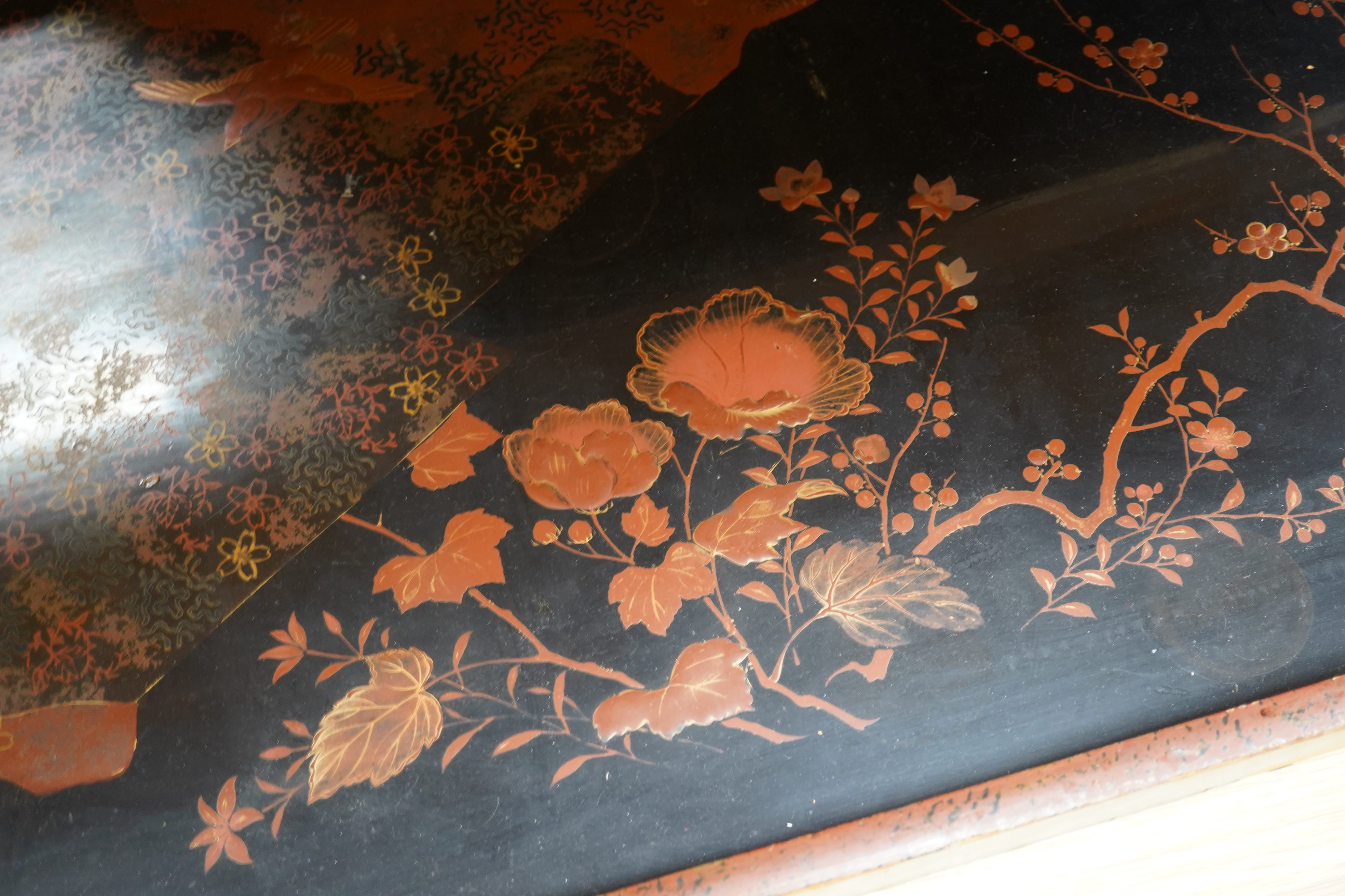 Three trays to include a butterfly wing example and a Japanese lacquered example decorated with birds and flowers, 75cm wide. Condition - poor to fair